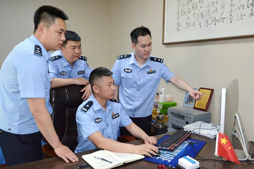 鄭群(右二)正在和同事研究案件